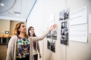 two women looking at pictures on the wall