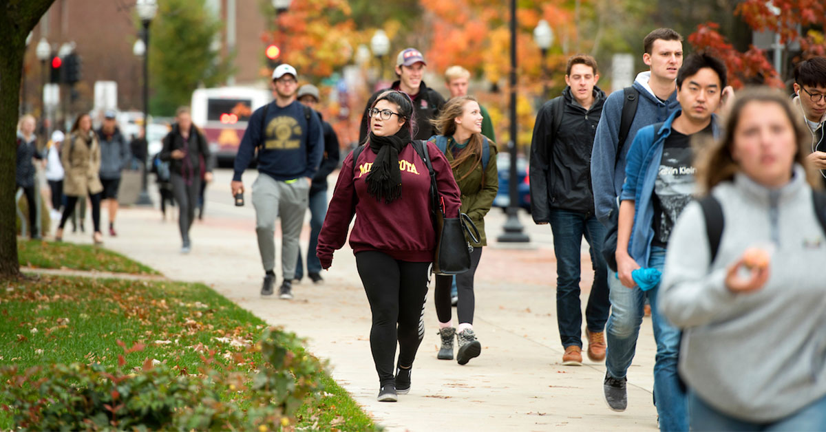Students walking outdoors on the University of Minnesota campus
