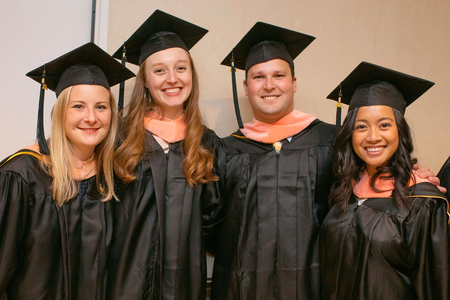 students smiling at the 2019 commencement ceremony