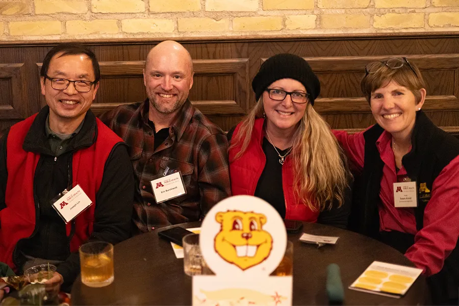 alumni-connect alumni smiling at a table